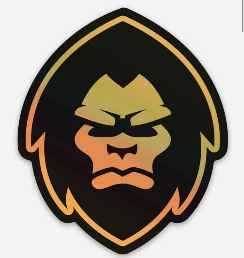Black, gold and orange stylized MÖTÖX sasquatch head mark